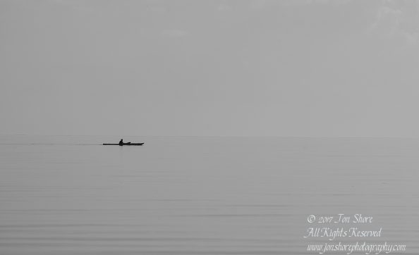 Kayak on still sea Tuja Latvia BW, Tamron 300mm
