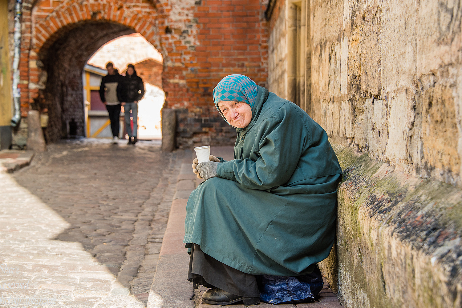 Smiling old woman in Riga Latvia old town. Nikkor 200mm