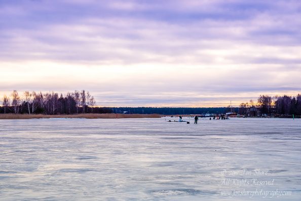 Ice Fishing on the Lielupe River in Latvia. Nikkor 300mm